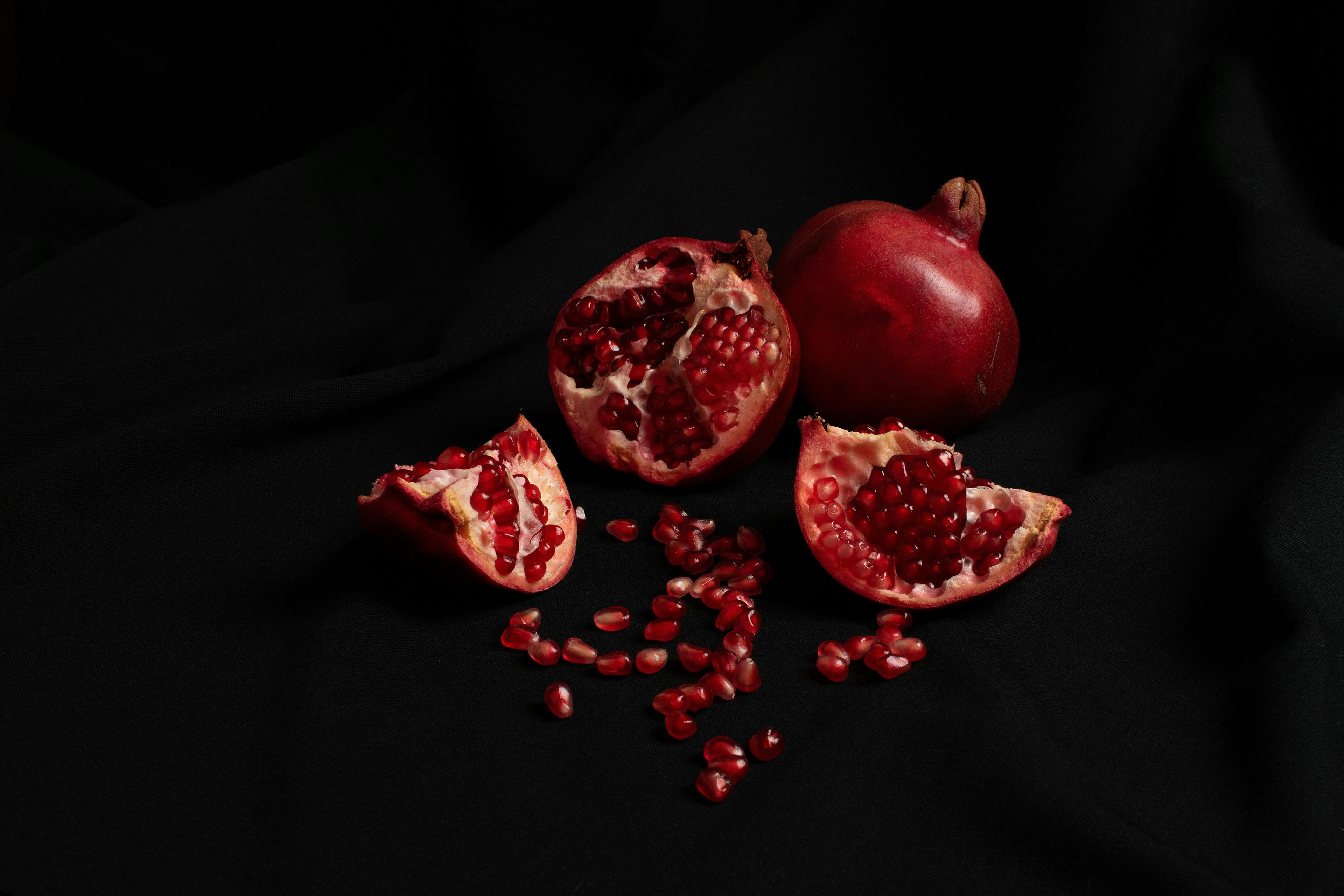 Pomegranates growing on a tree branch, symbolizing growth and nature.